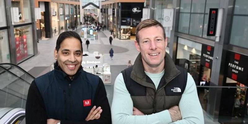 Two people smiling in The Centre, Livingston