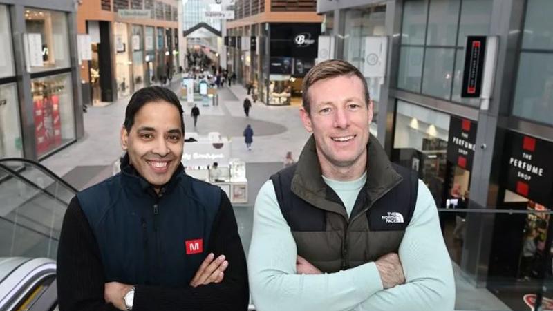 Two people smiling in The Centre, Livingston