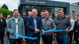 People cutting a rope to officially open the new headquarters